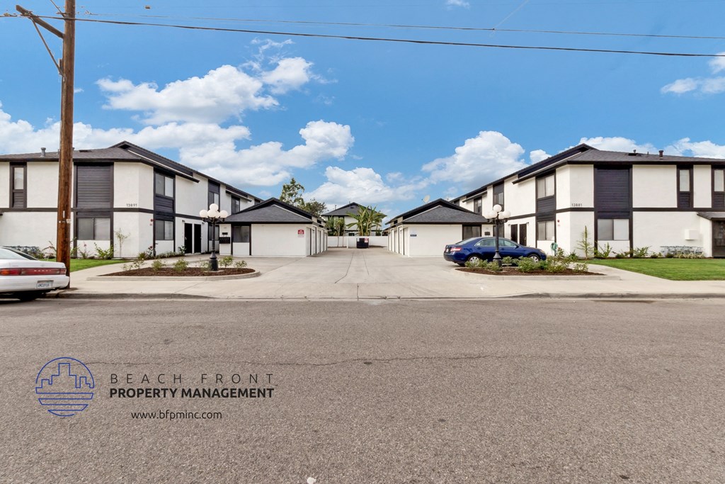 a row of houses on a street with a car parked in front of it