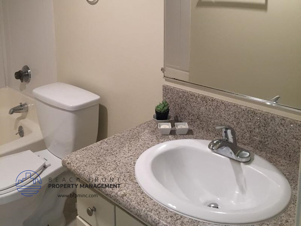 a bathroom with a sink and a toilet and a mirror