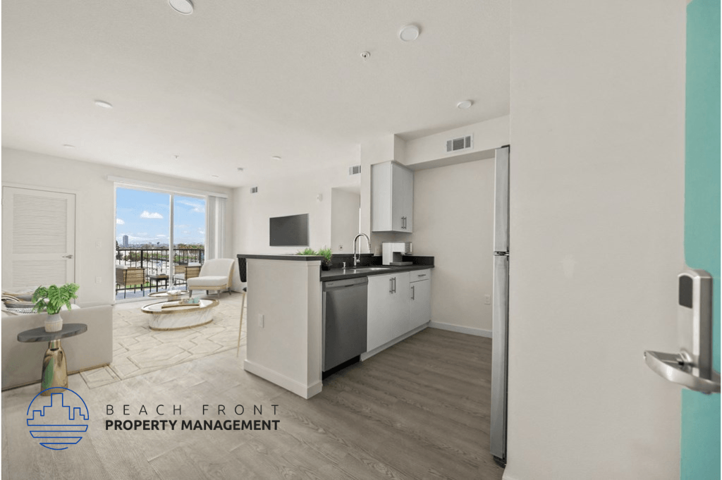 a kitchen with white cabinets and a large window