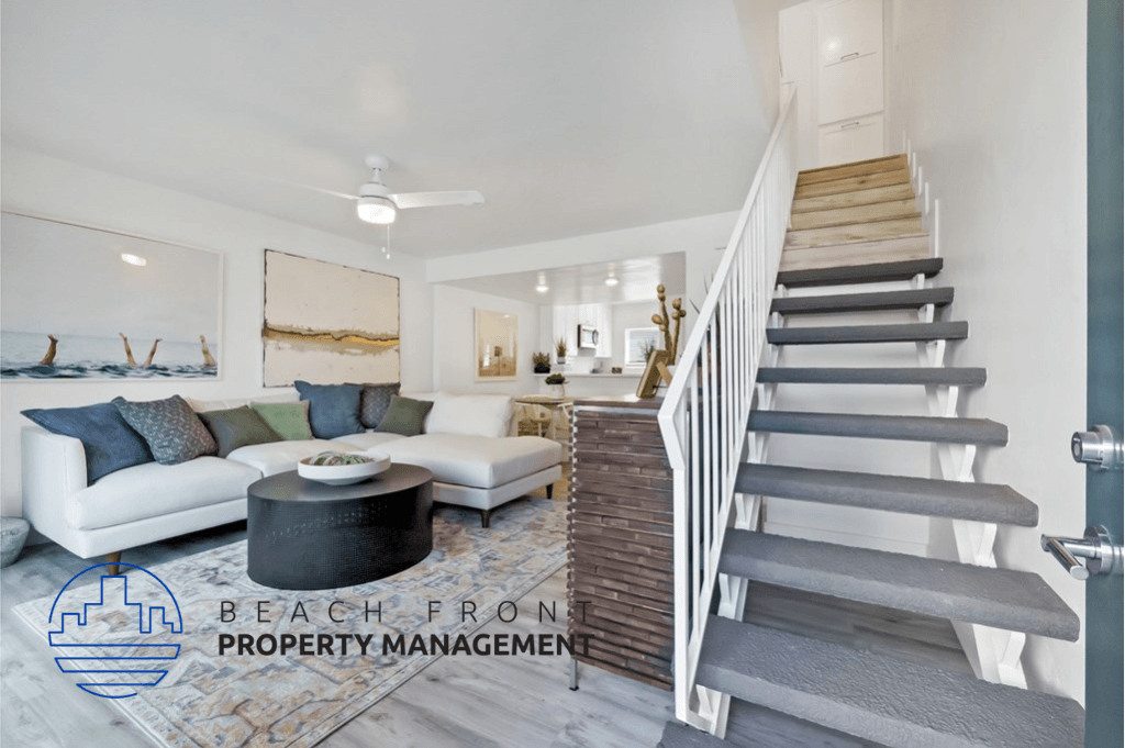 an image of a living room with a staircase and a couch