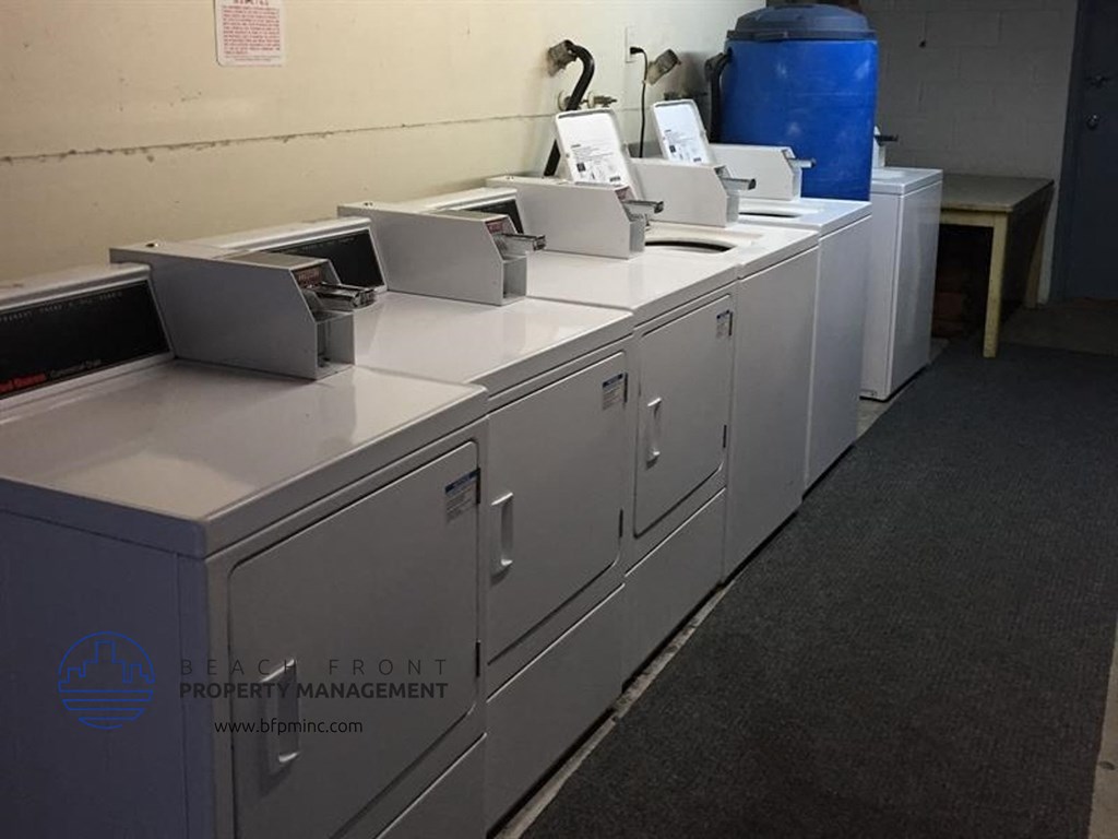 a row of white counters with laptops on them