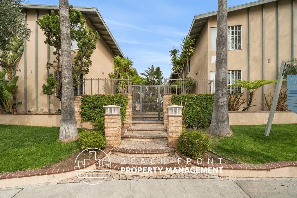 a house with a stairway and palm trees