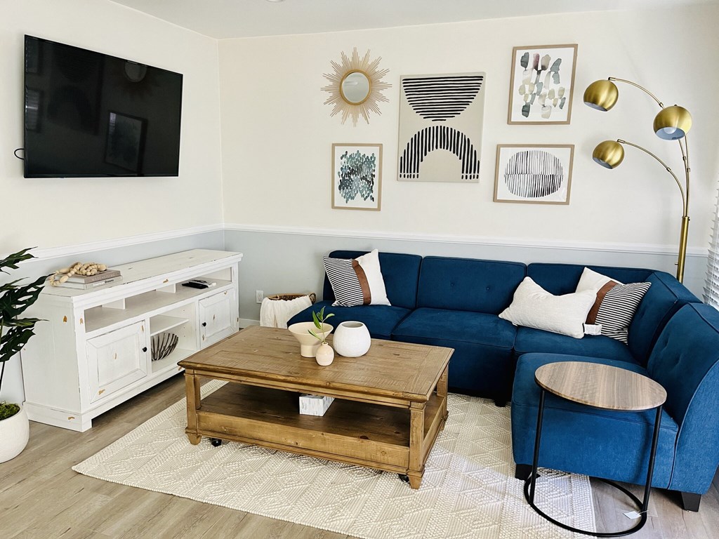 a living room with a blue couch and a coffee table