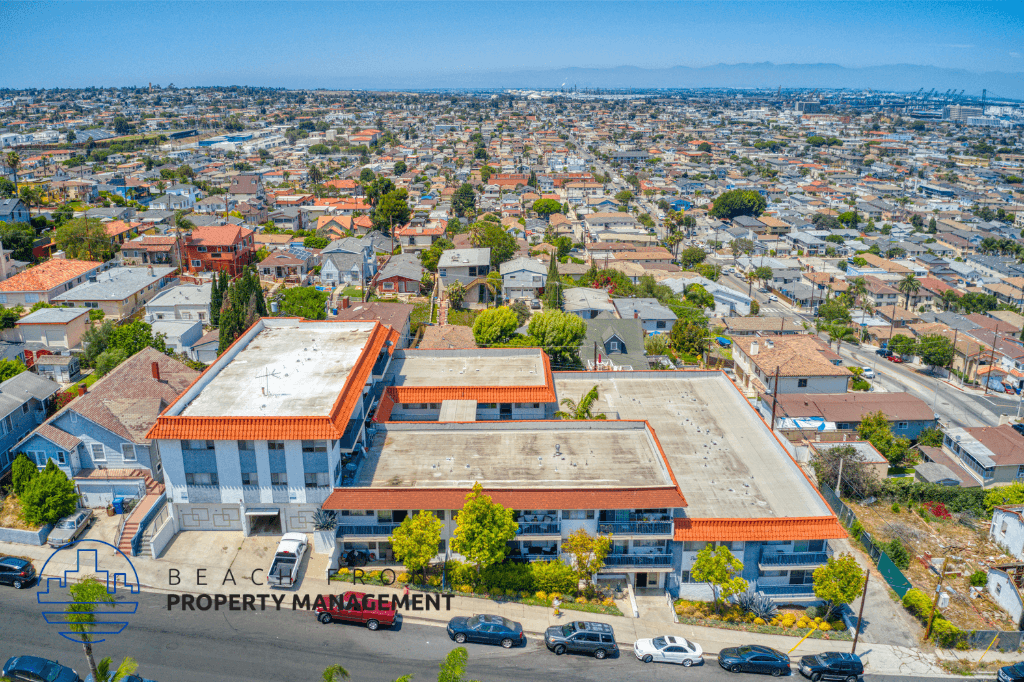 an aerial view of two buildings with a city in the background