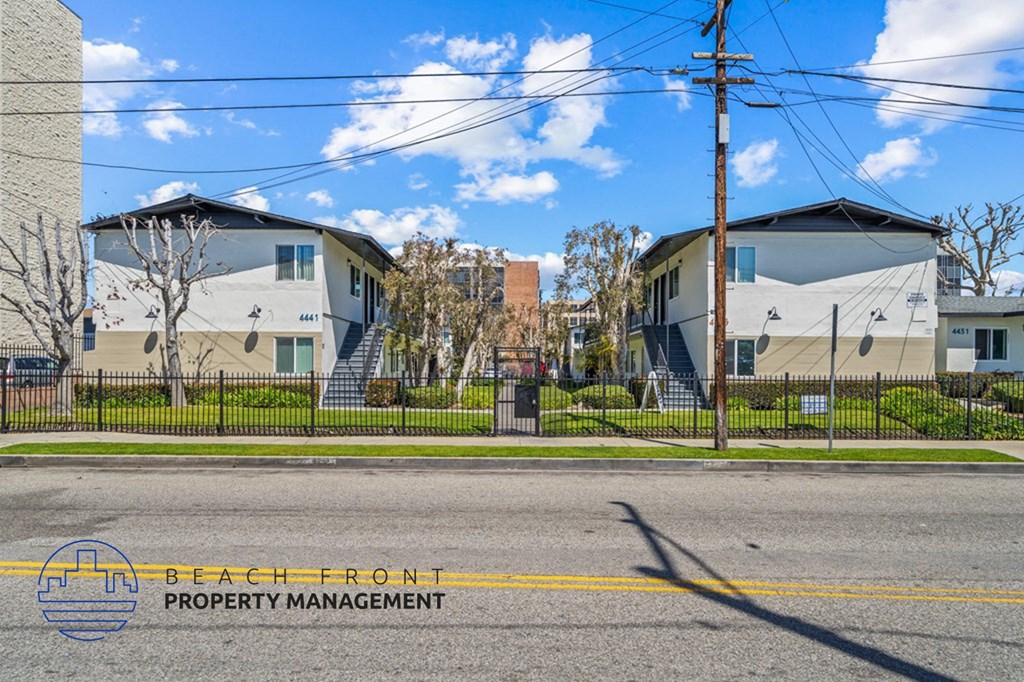 a street view of a row of houses on the side of a street