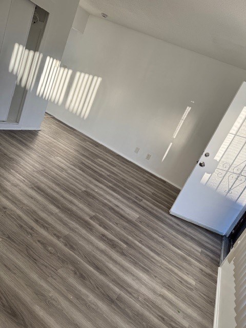 A room with a wooden floor and white walls.