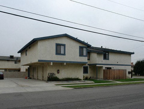 a white house sitting on the side of a street