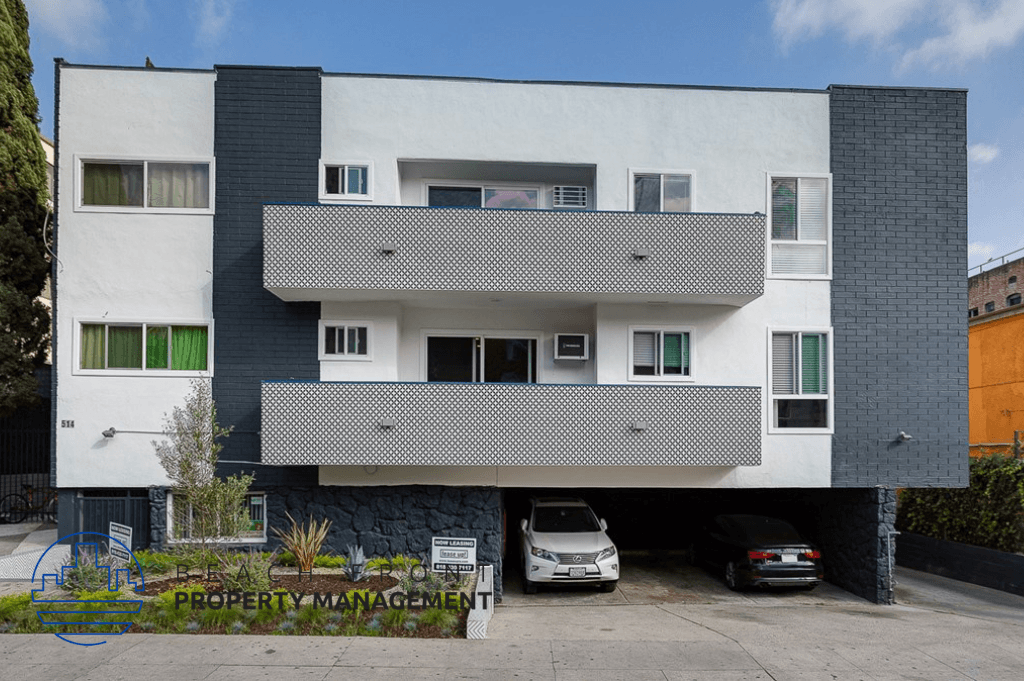an apartment building with cars parked in front of it
