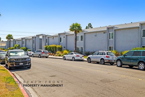 a city street with cars parked in front of a building