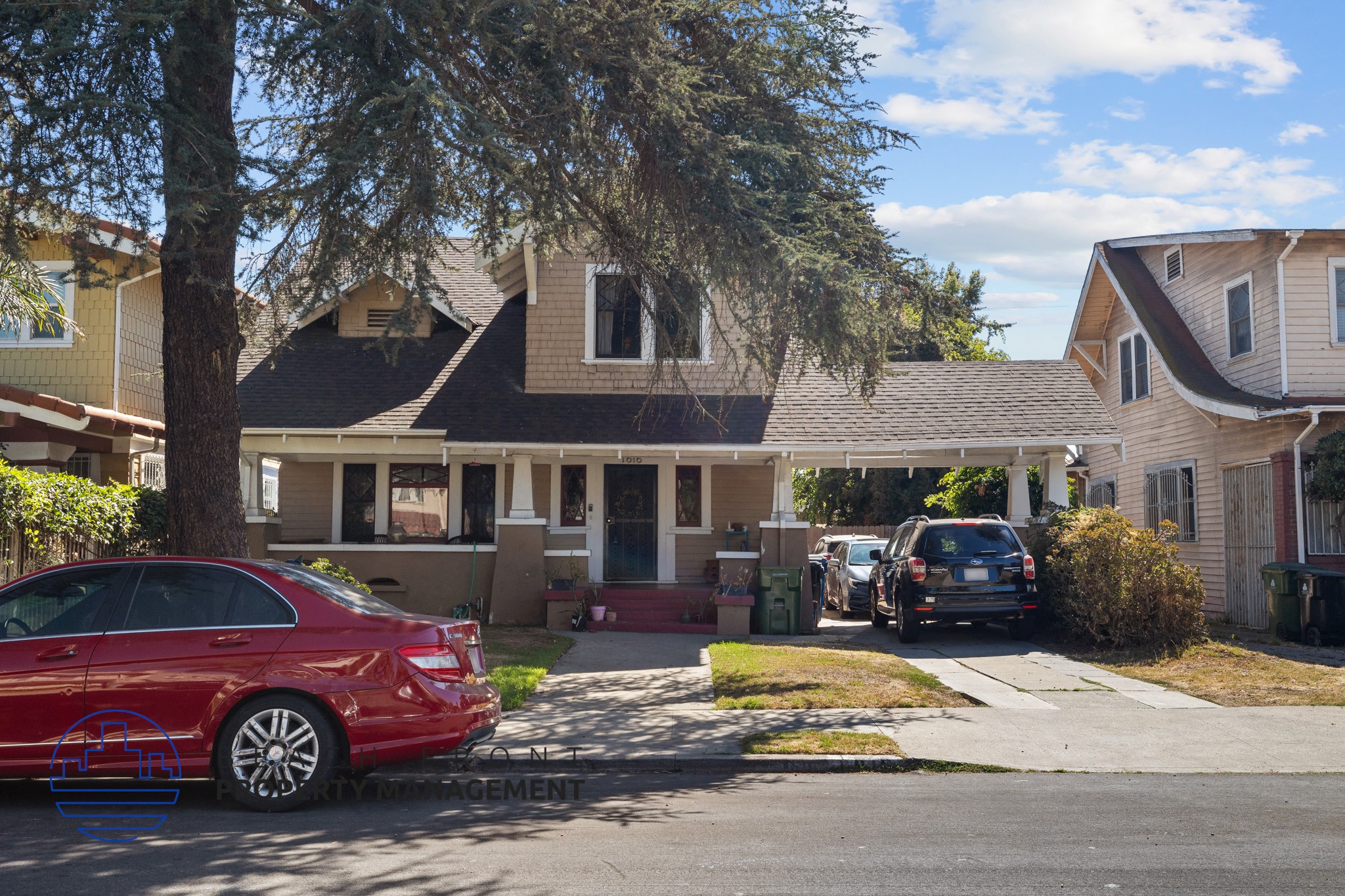 two cars parked in front of a house