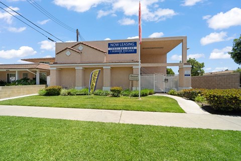A building with a sign that says "Now Leasing" on it.