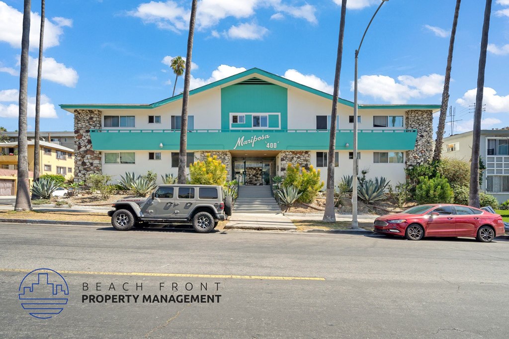 A car is parked in front of a building with a sign that says "Mirage 203".