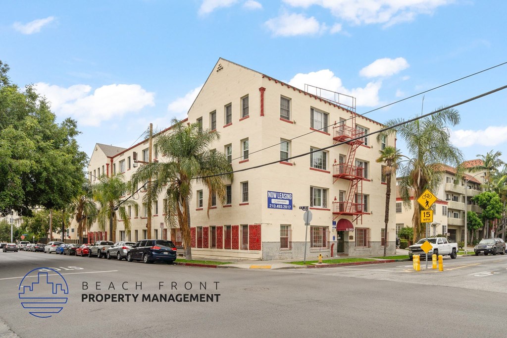A street view of a building with the sign "BEACH FRONT PROPERTY MANAGEMENT" in front of it.