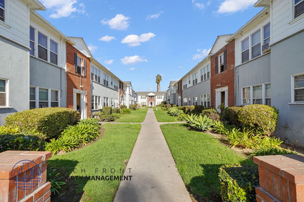 A row of houses with a pathway in the middle.