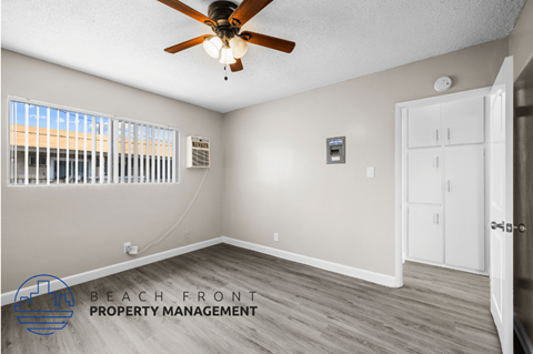a living room with a ceiling fan and a window