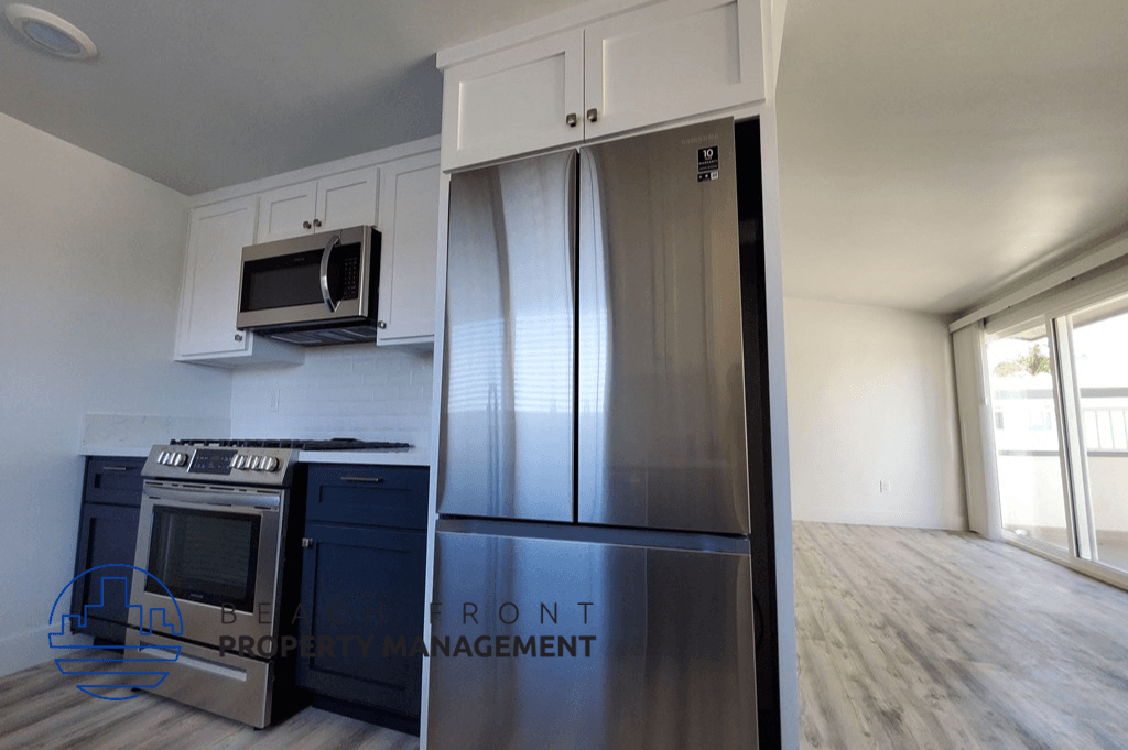 a kitchen with stainless steel appliances and white cabinets