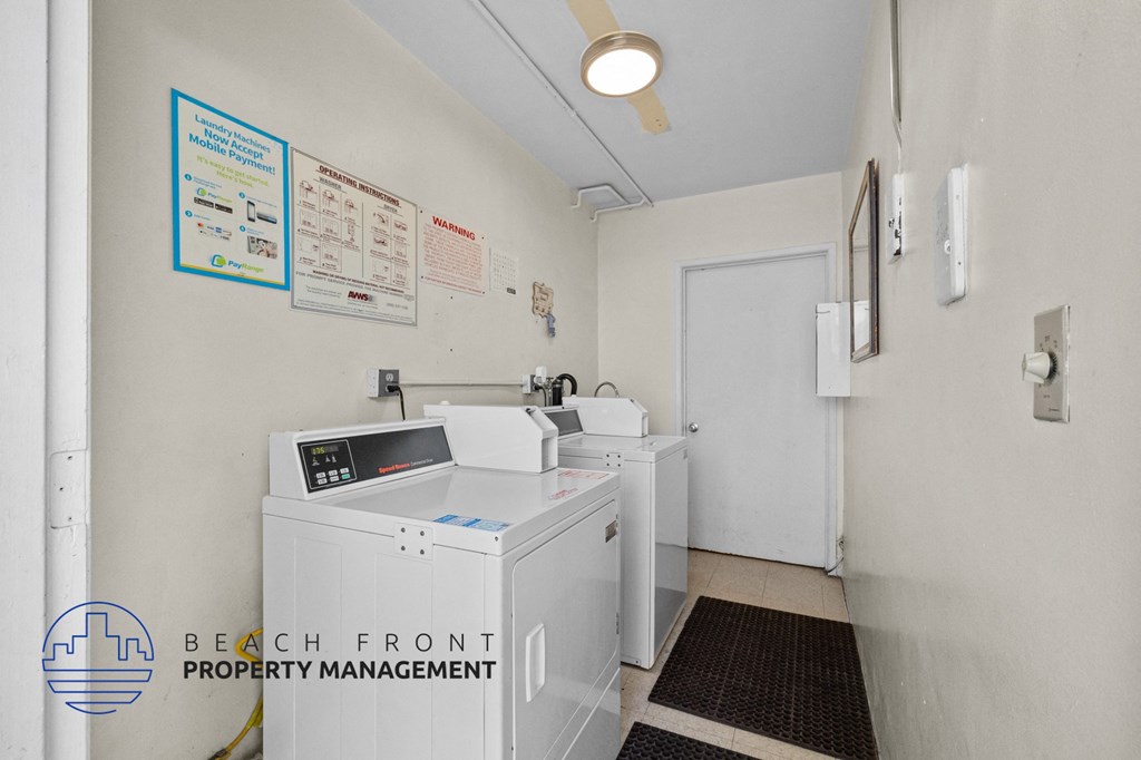 a laundry room with two washing machines and a door