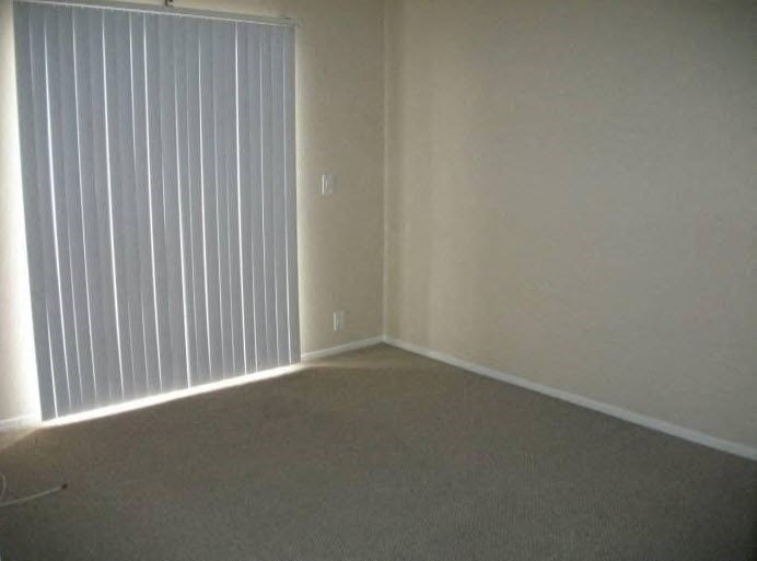 an empty living room with a large window