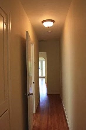 a hallway with a door and a light on the ceiling