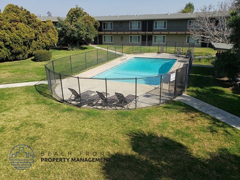 a backyard with a pool and a chain link fence around it