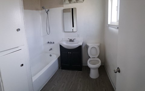 a bathroom with a toilet and a sink and a bath tub