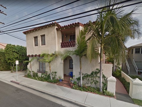 a house with palm trees in front of it
