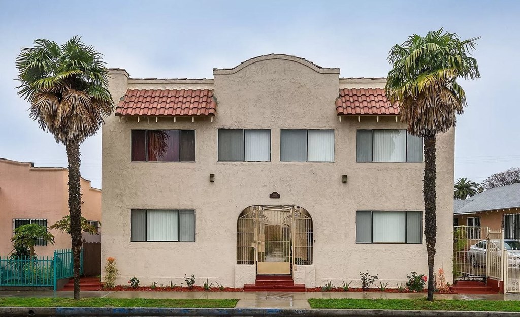 a house with two palm trees in front of it