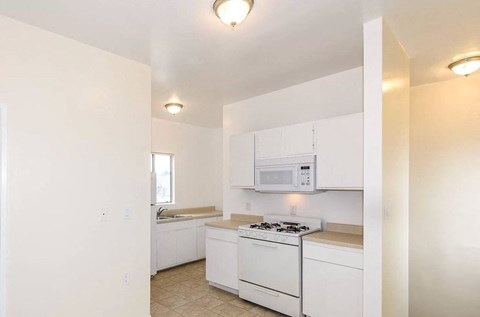 a kitchen with white appliances and white cabinets