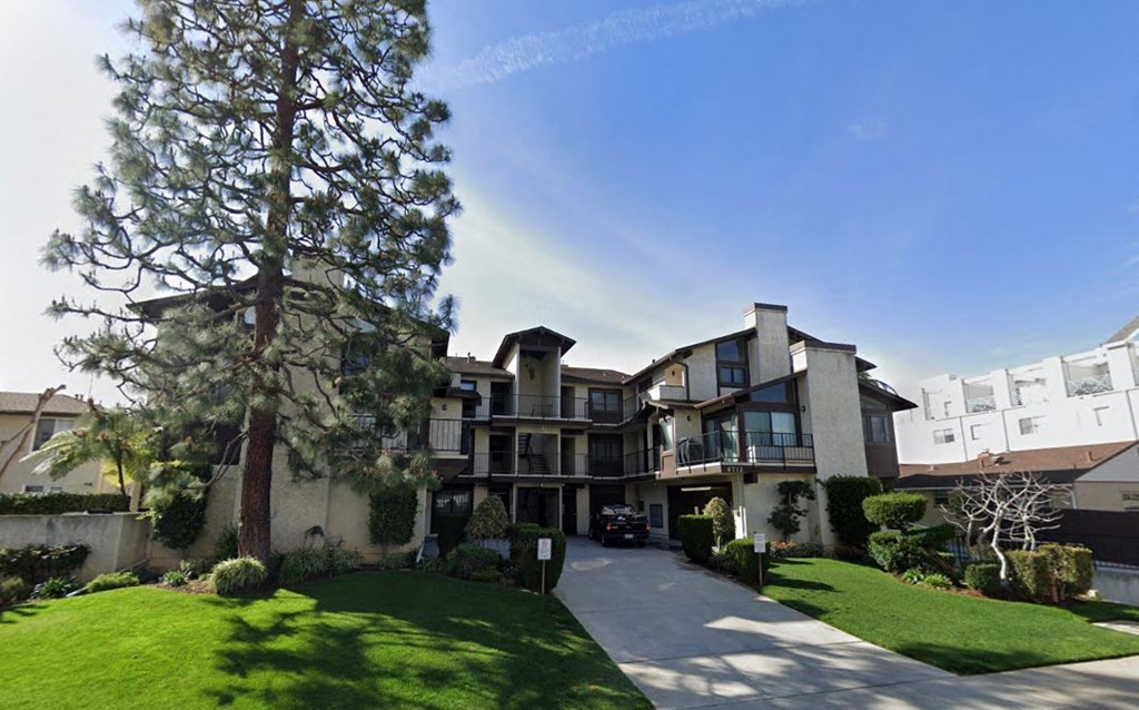 A large house with a tree in front of it.