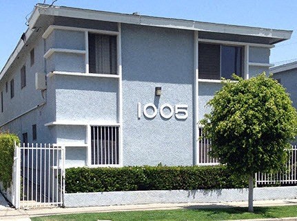 A grey building with the number 1008 on it.