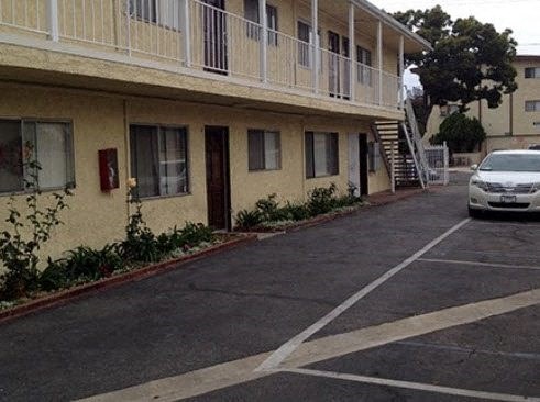 a car parked in a parking lot in front of a building