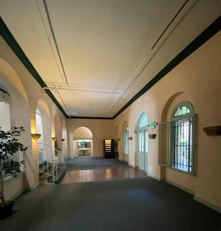 a large hallway in a building with large windows