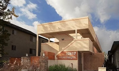 A modern building with the number 12617 Azure Heights on its signboard.