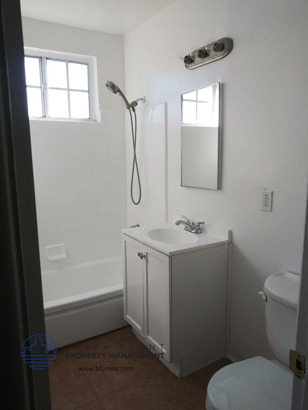 a small bathroom with a sink and shower and a toilet