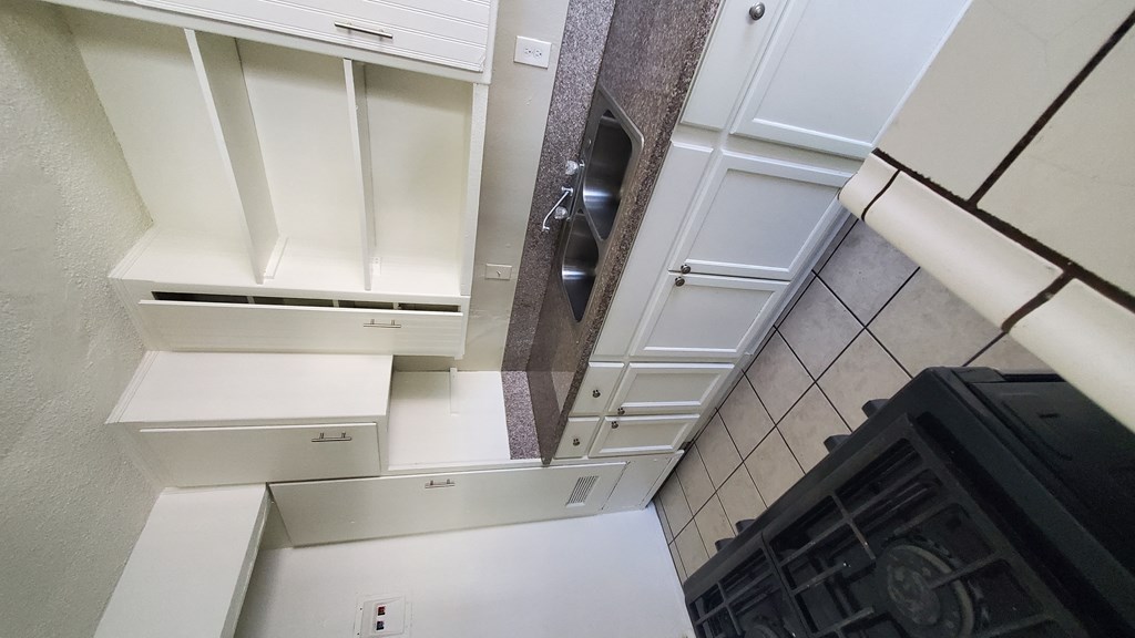 an overhead view of a kitchen with white cabinets
