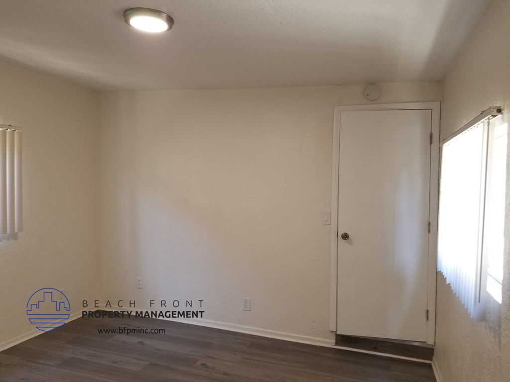 an empty room with white walls and a white door