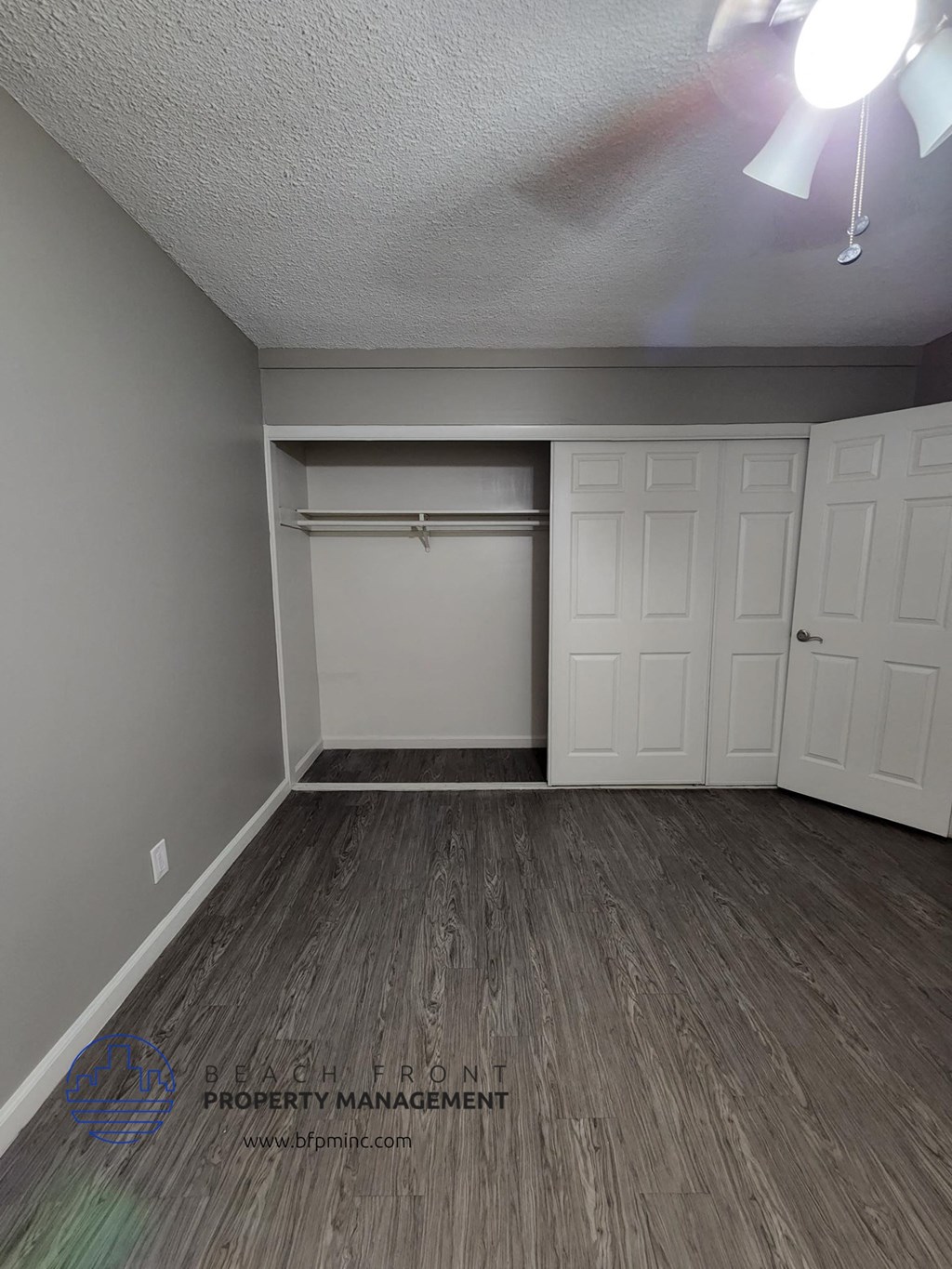 the upstairs bedroom has a closet and hardwood floor