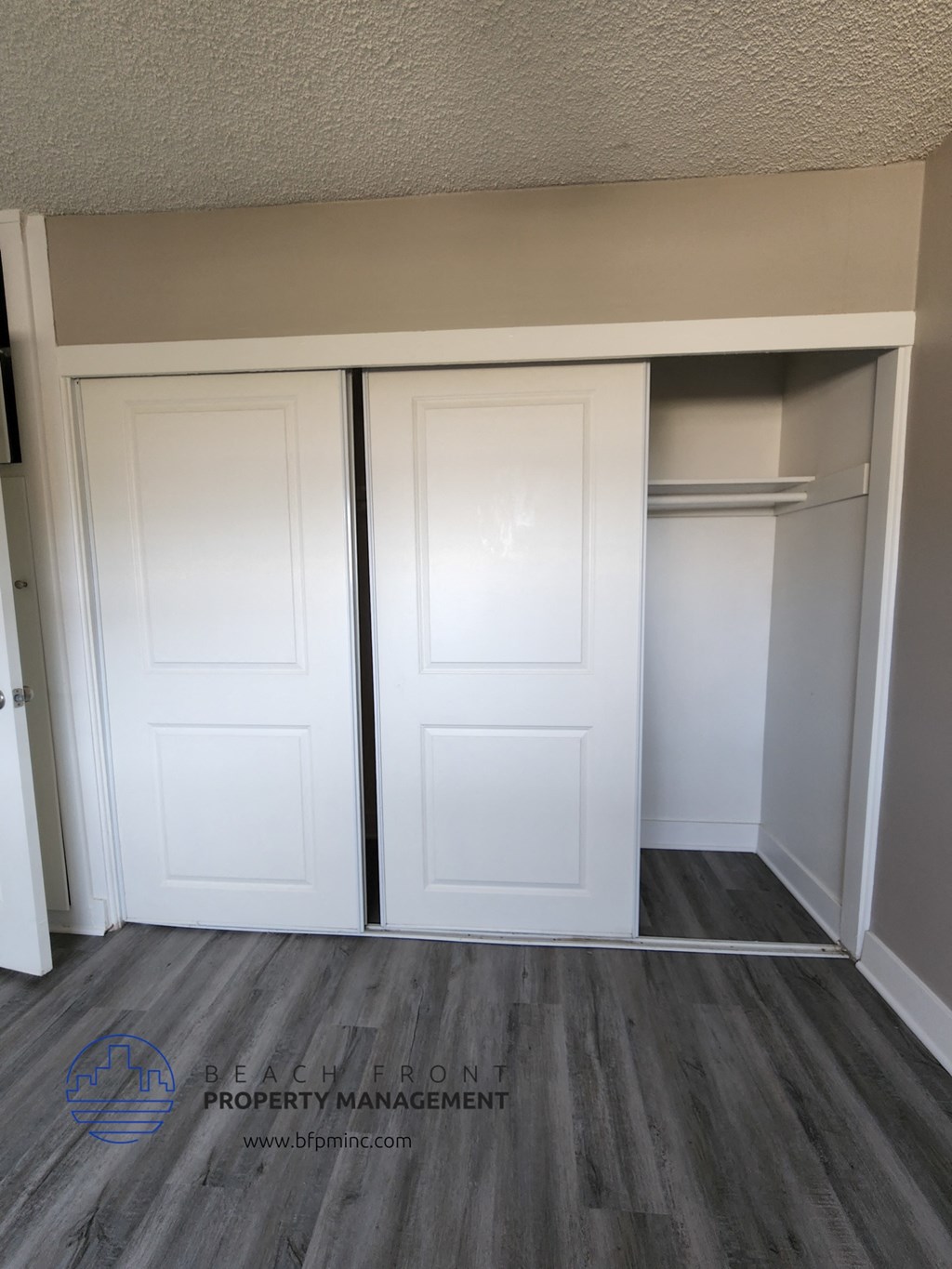 a pair of closet doors in a room with a wood floor