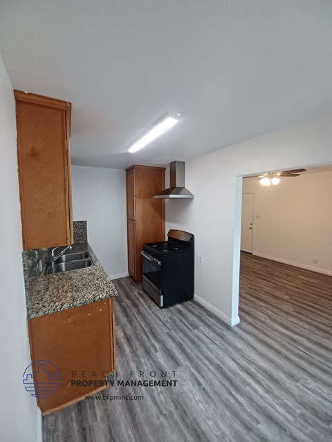 a kitchen and living room of an empty apartment