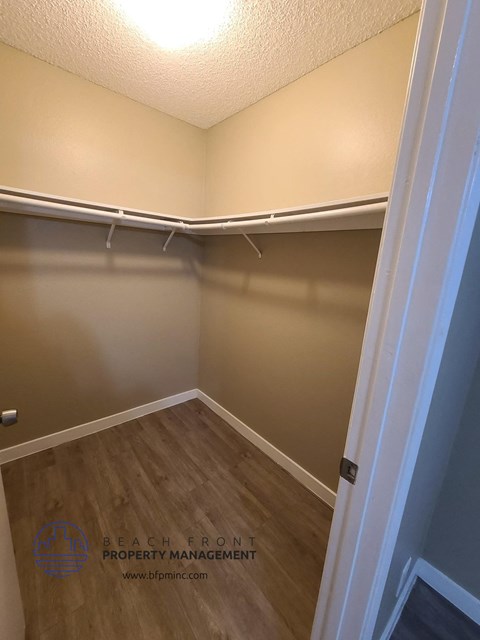 a empty room with a closet and a hard wood floor
