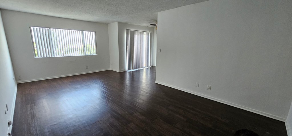 an empty living room with a large window