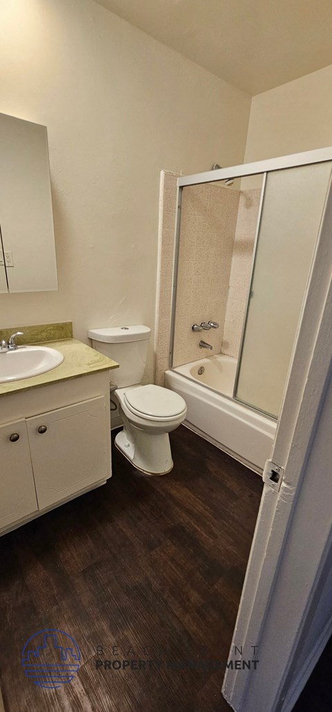 a bathroom with a toilet and a sink and a shower