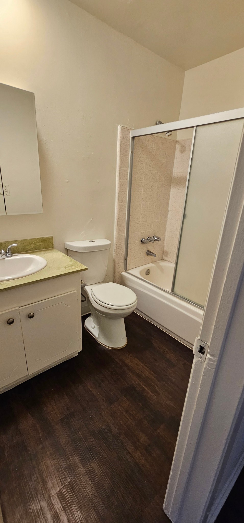 a bathroom with a toilet sink and shower