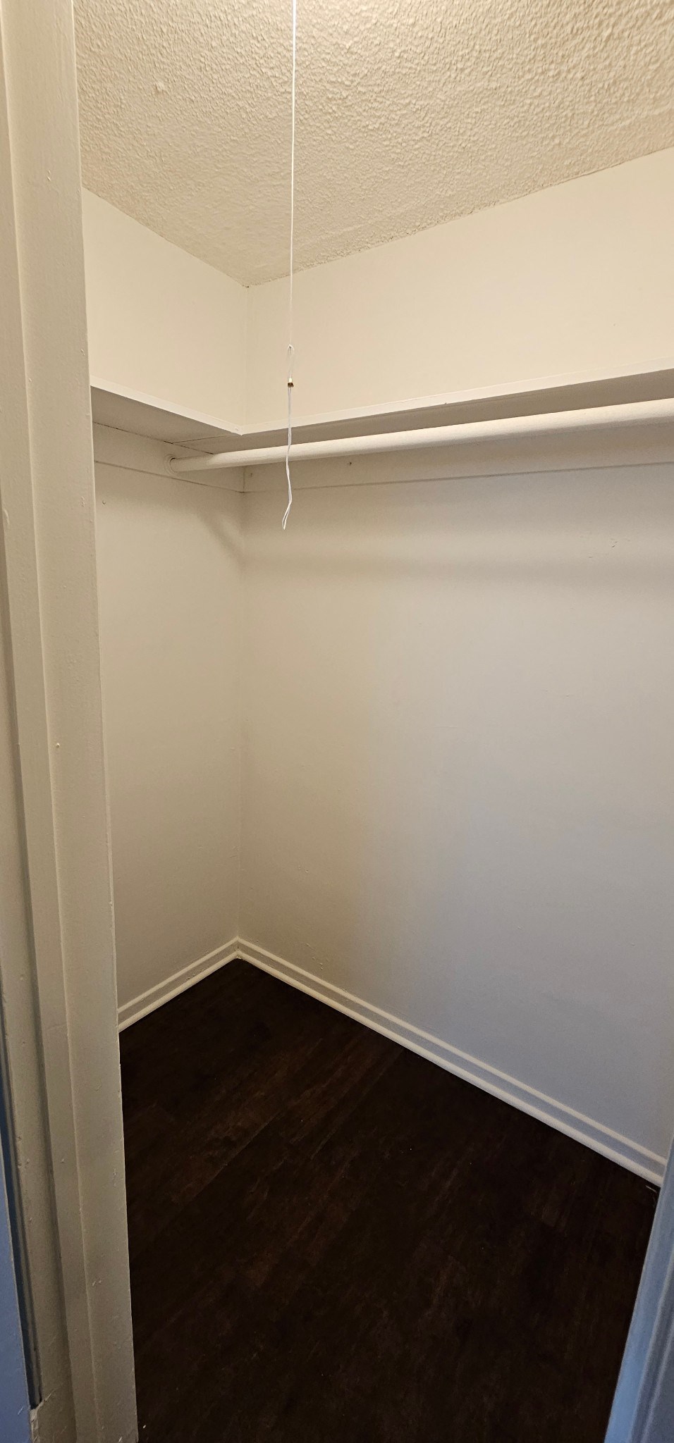 a small room with a wooden floor and white walls