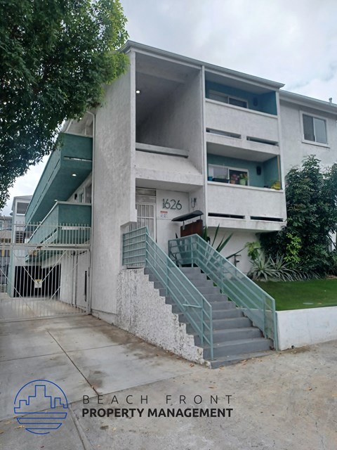 an apartment building with stairs in front of it