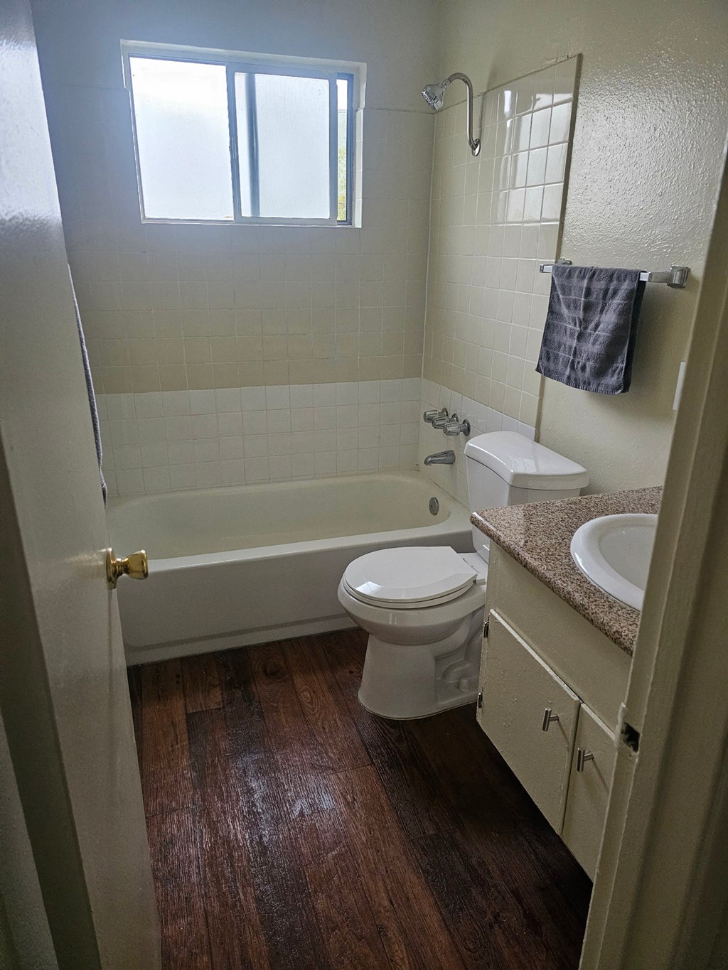 a bathroom with a toilet and a tub and a sink
