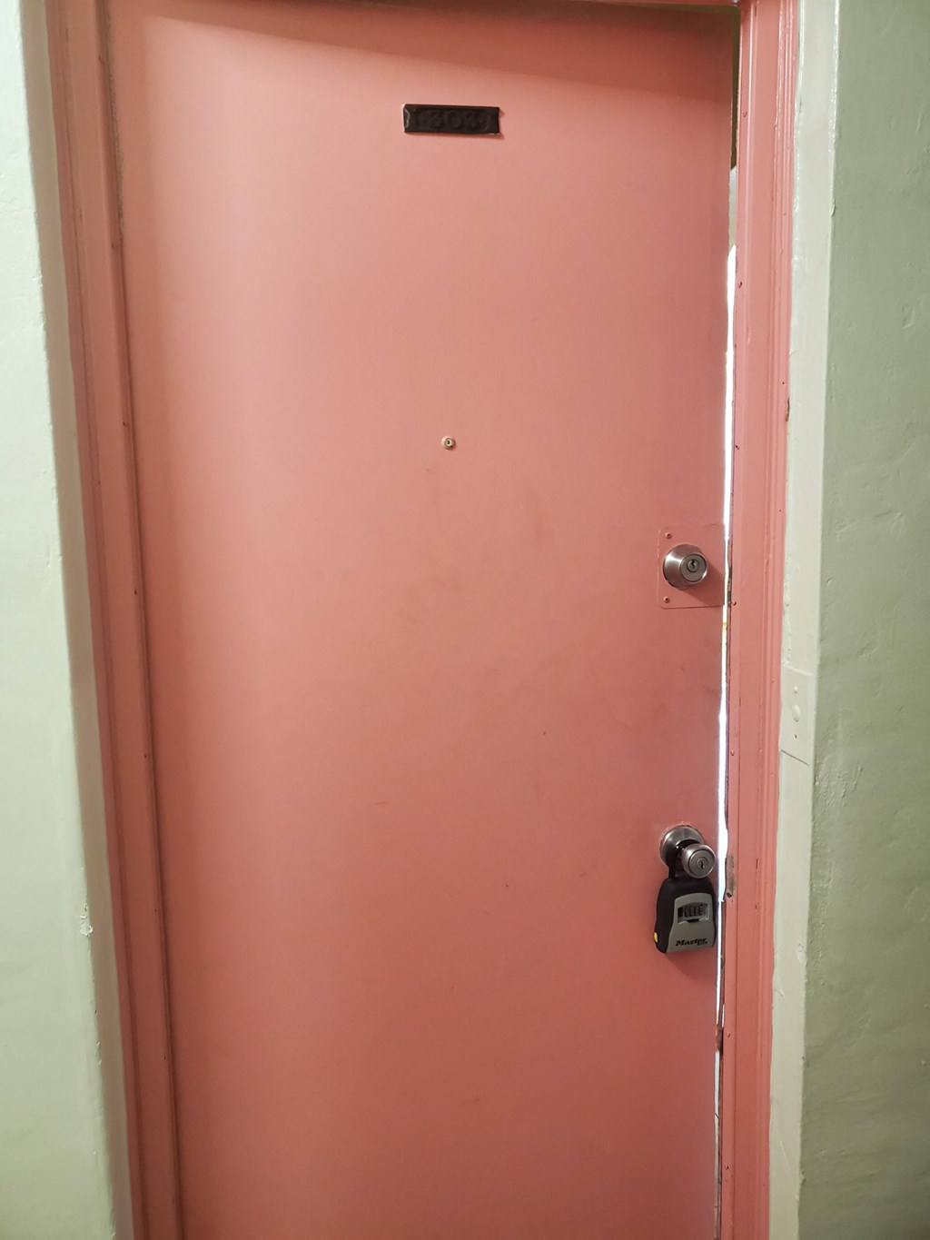 a pink door with a lock on it
