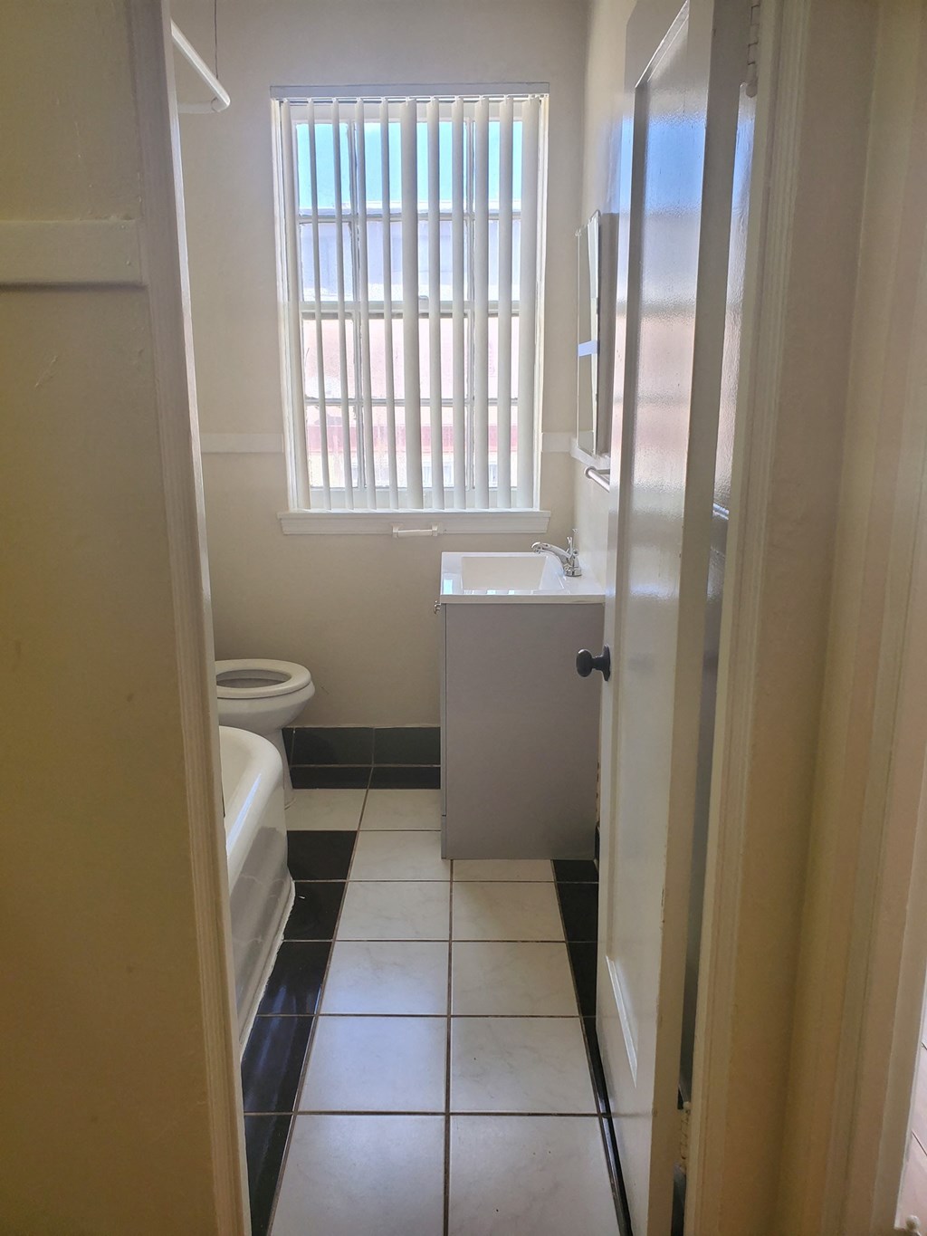 a small bathroom with a toilet and a sink and a window