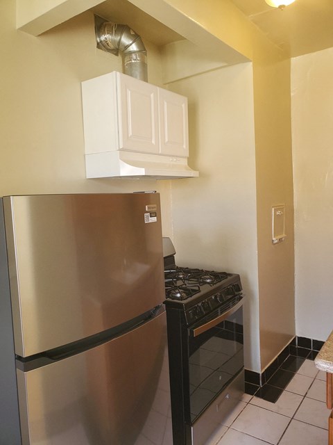 a kitchen with a stove and a refrigerator