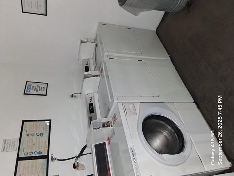 A washing machine with a control panel and a digital display.